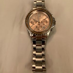 Michael Kors watch with silver band and light pink crystals around the face